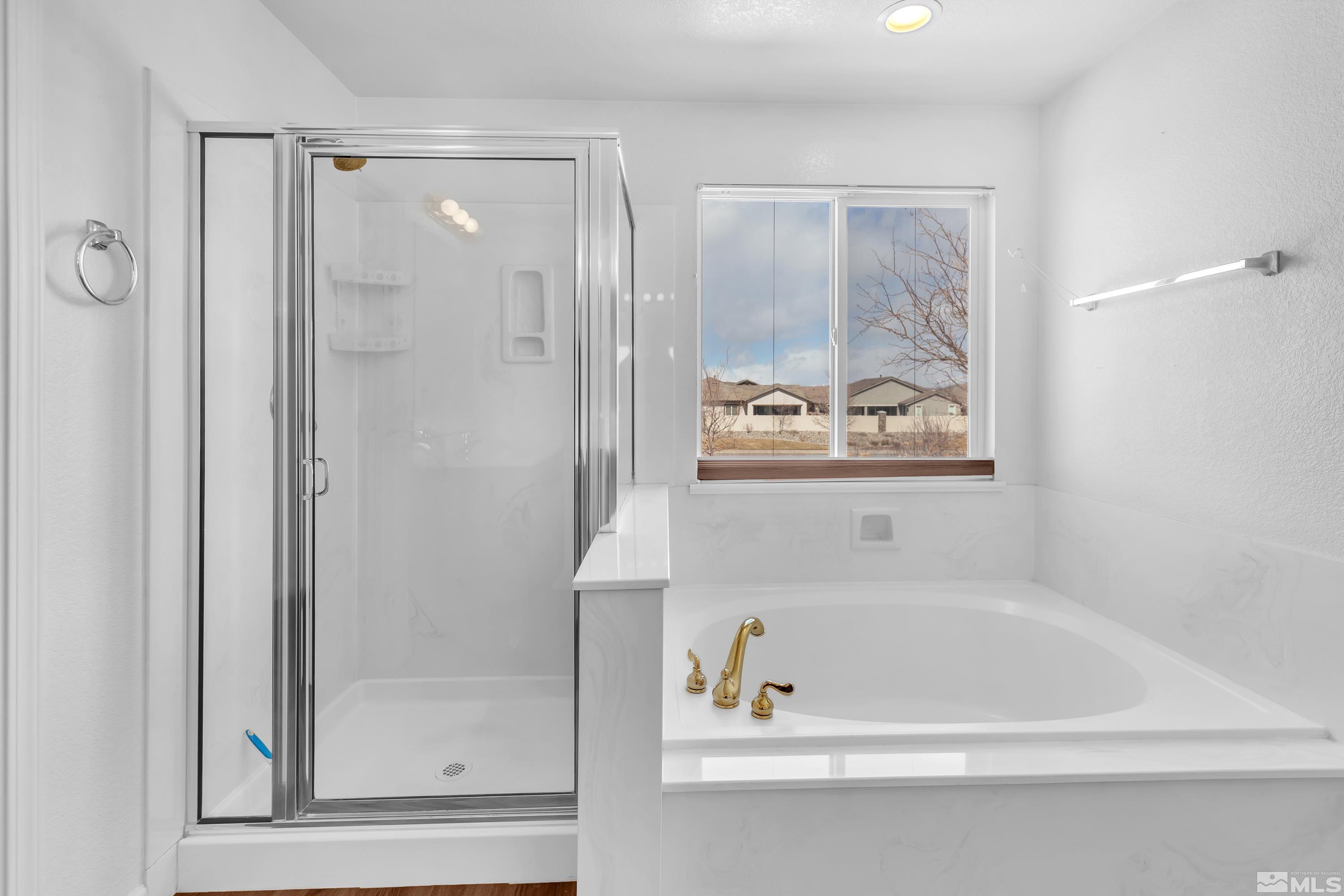 2325 Lincoln Meadows Drive Reno, NV 89521 - Photo 25 of 40 a bathroom with a bathtub and a shower