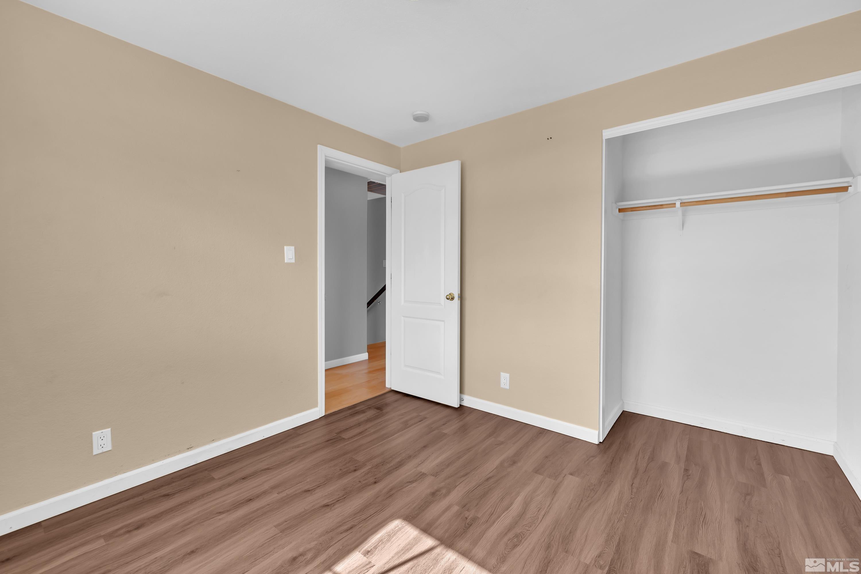 2325 Lincoln Meadows Drive Reno, NV 89521 - Photo 27 of 40 a view of an empty room with wooden floor