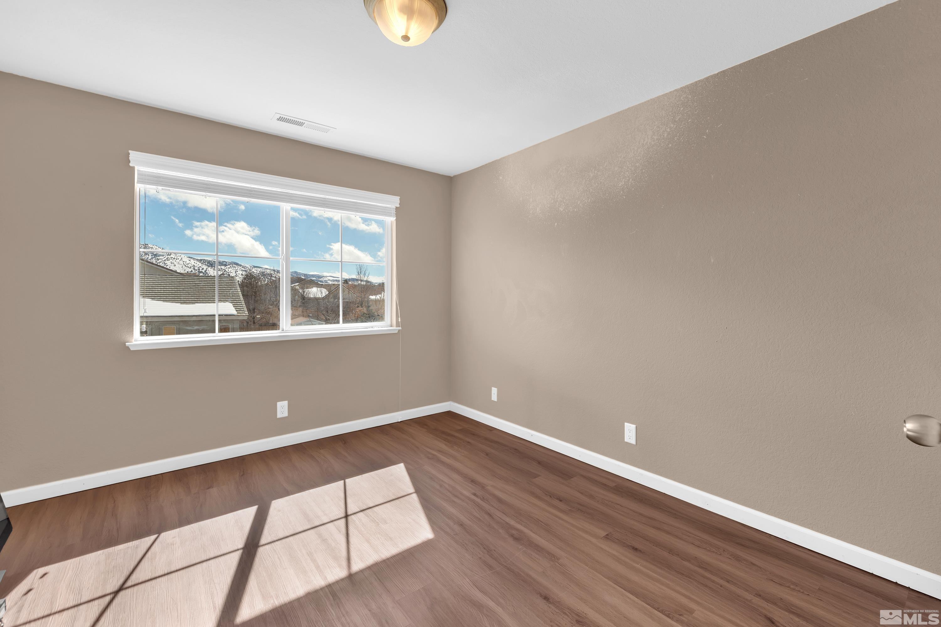 2325 Lincoln Meadows Drive Reno, NV 89521 - Photo 28 of 40 a view of empty room with wooden floor and fan