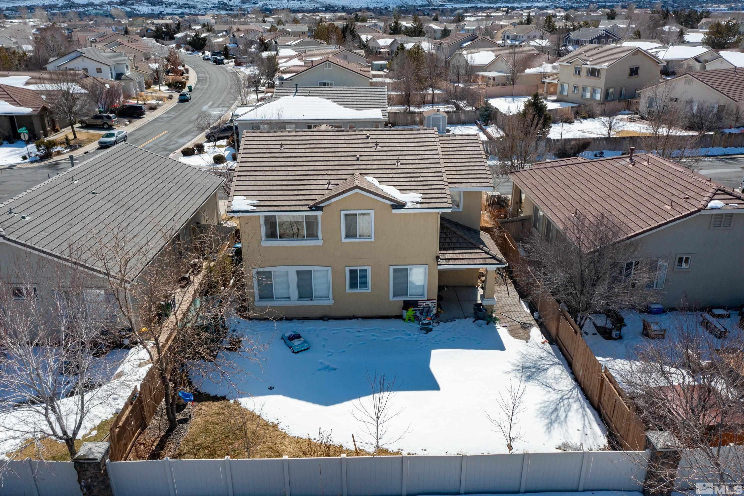 2325 Lincoln Meadows Drive Reno, NV 89521 - Photo 35 of 40 a view of a house with roof deck front door and outdoor seating