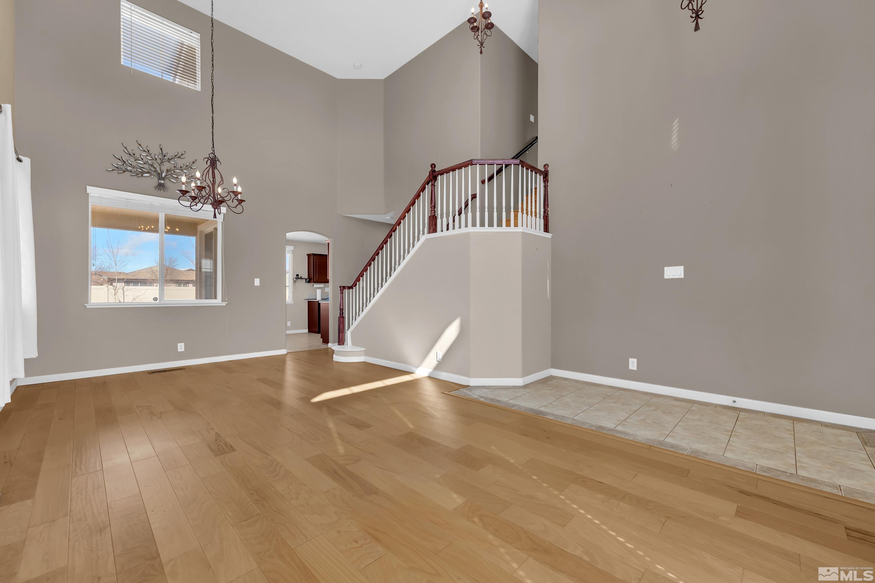 2325 Lincoln Meadows Drive Reno, NV 89521 - Photo 6 of 40 a view of an empty room with wooden floor and a window