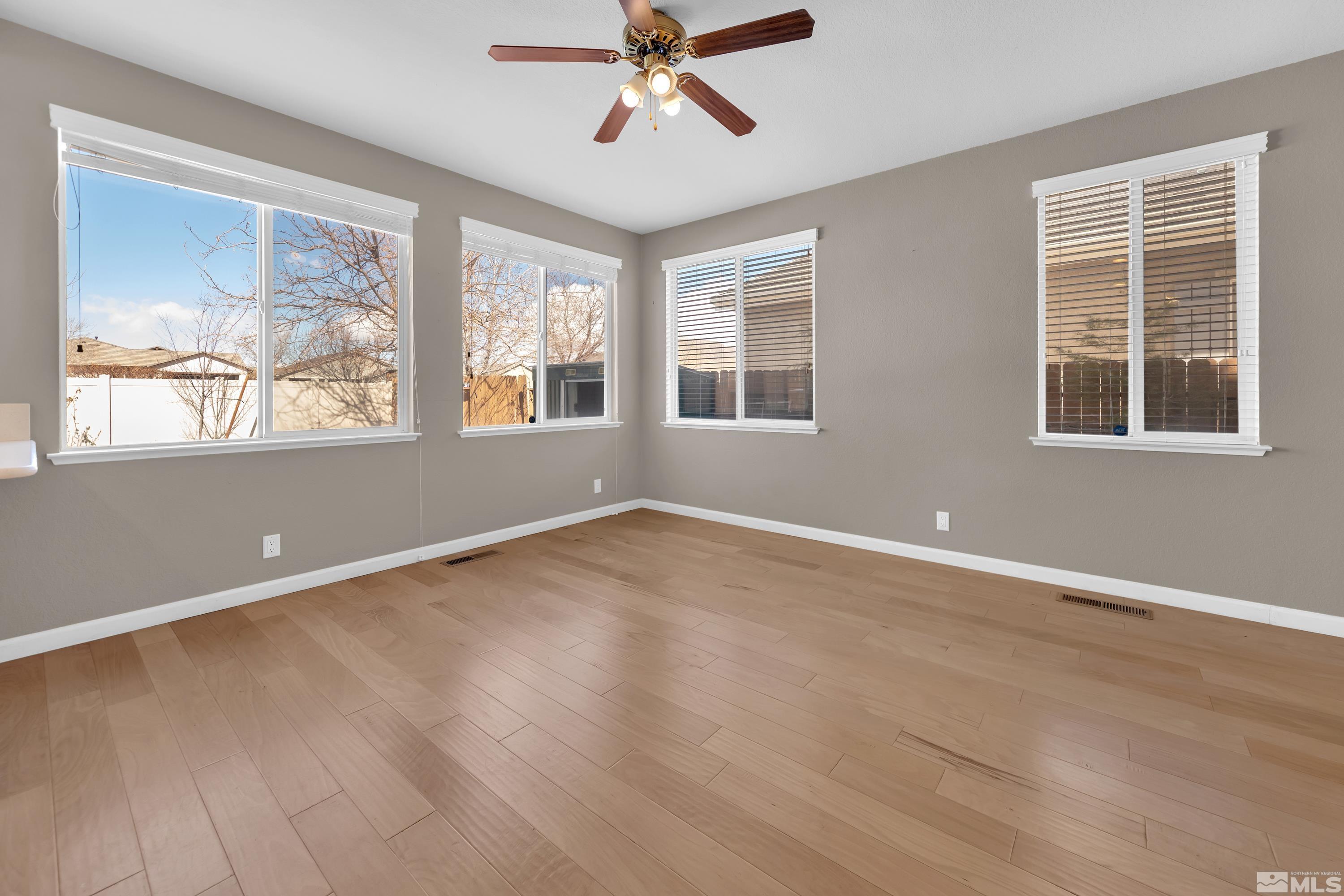 2325 Lincoln Meadows Drive Reno, NV 89521 - Photo 8 of 40 wooden floor in an empty room with a window