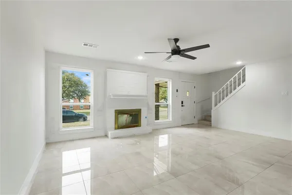 a view of a livingroom with a fireplace and window