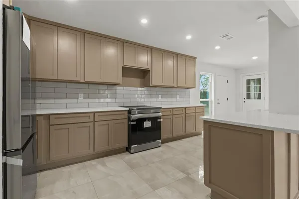a kitchen with stainless steel appliances granite countertop wooden cabinets a stove top oven a sink and dishwasher