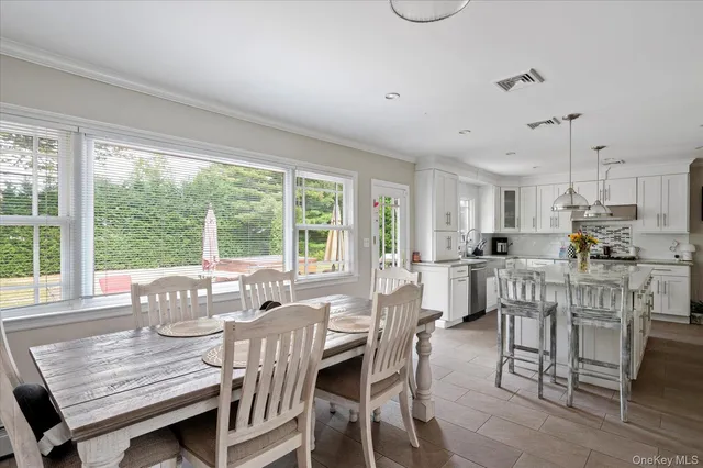 a view of a dining room with furniture window and outside view