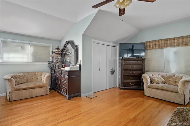 a living room with furniture and a dresser