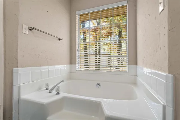 a white bath tub sitting next to a white sink