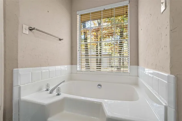 a white bath tub sitting next to a white sink