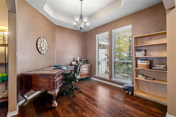 a view of a workspace with furniture and a window
