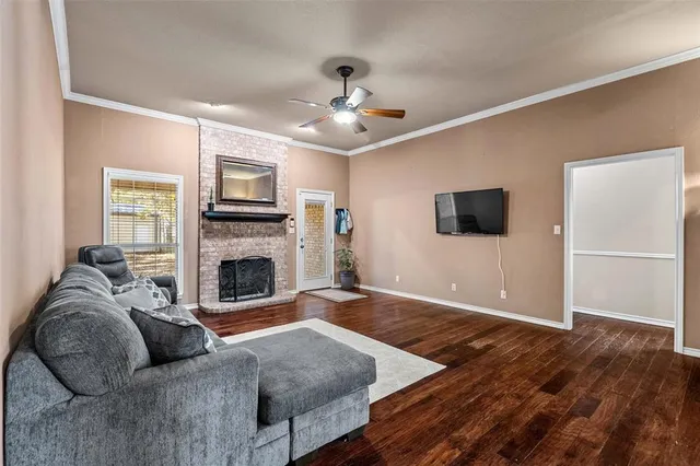 a living room with furniture a flat screen tv and a fireplace