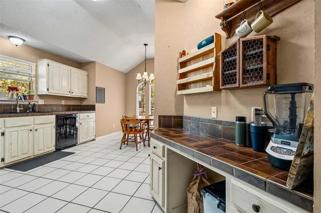 a kitchen with appliances cabinets and furniture