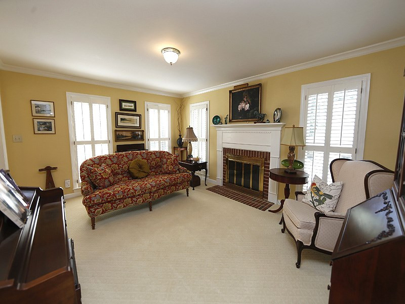 6907 Valley Drive Raleigh, NC 27612 - Photo 4 of 24 Masonry fireplace w/ wood mantle. Lots of natural light. Living Room