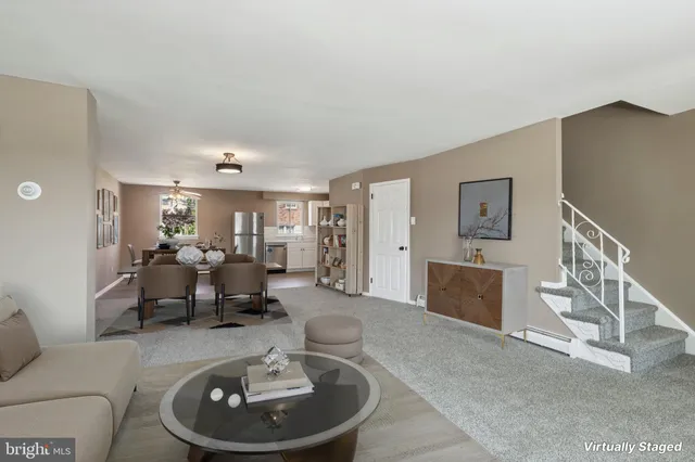 a living room with furniture and a dining table