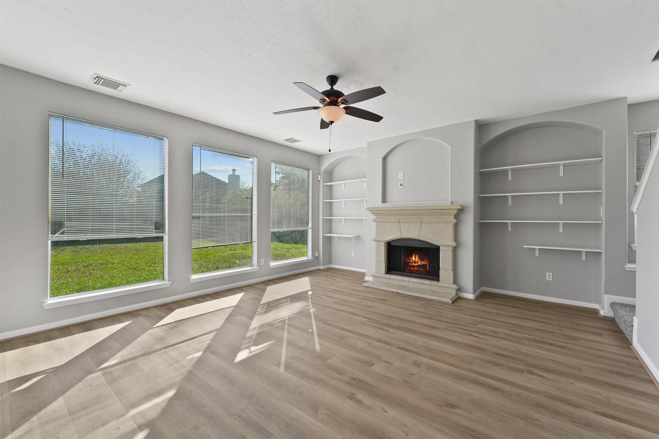 9107 Huckinston Court Spring, TX 77379 - Photo 13 of 32 a view of an empty room with a fireplace and a window