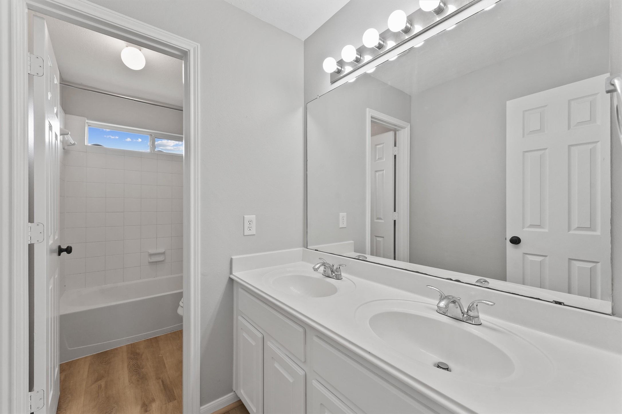 9107 Huckinston Court Spring, TX 77379 - Photo 19 of 32 a bathroom with a double vanity sink and a mirror