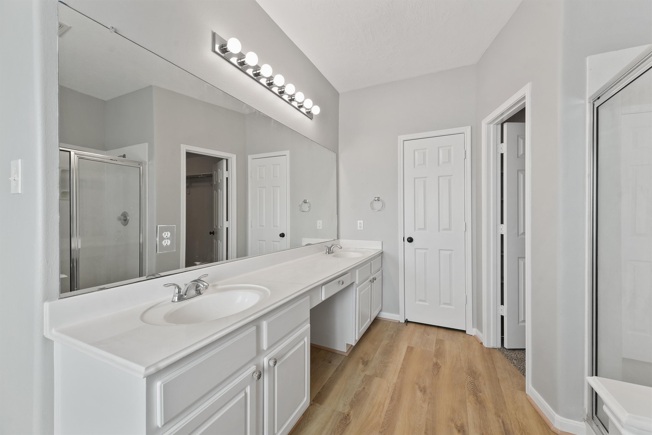 9107 Huckinston Court Spring, TX 77379 - Photo 25 of 32 a spacious bathroom with a double vanity sink and mirror