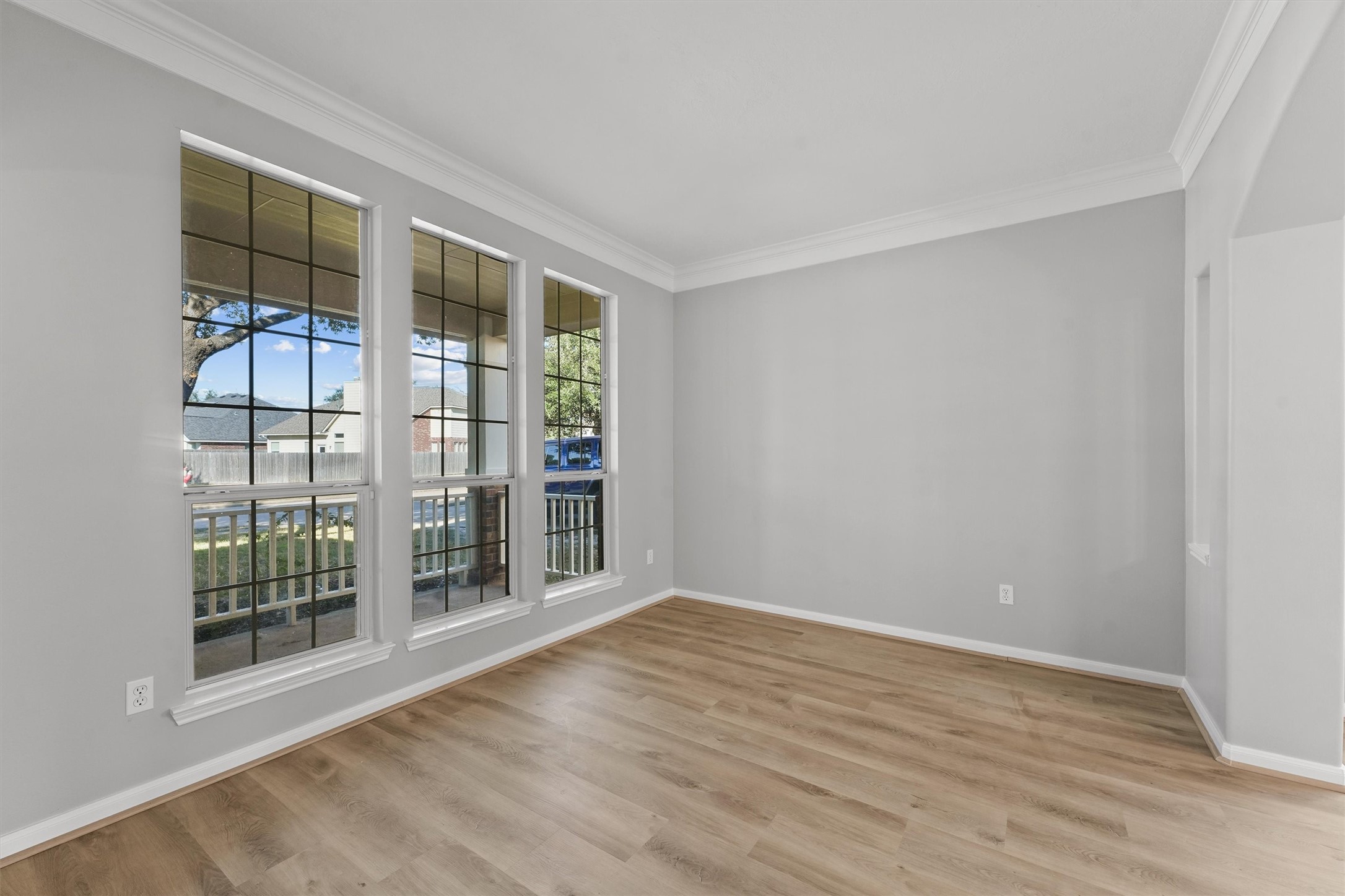 9107 Huckinston Court Spring, TX 77379 - Photo 6 of 32 a view of an empty room with wooden floor and a window