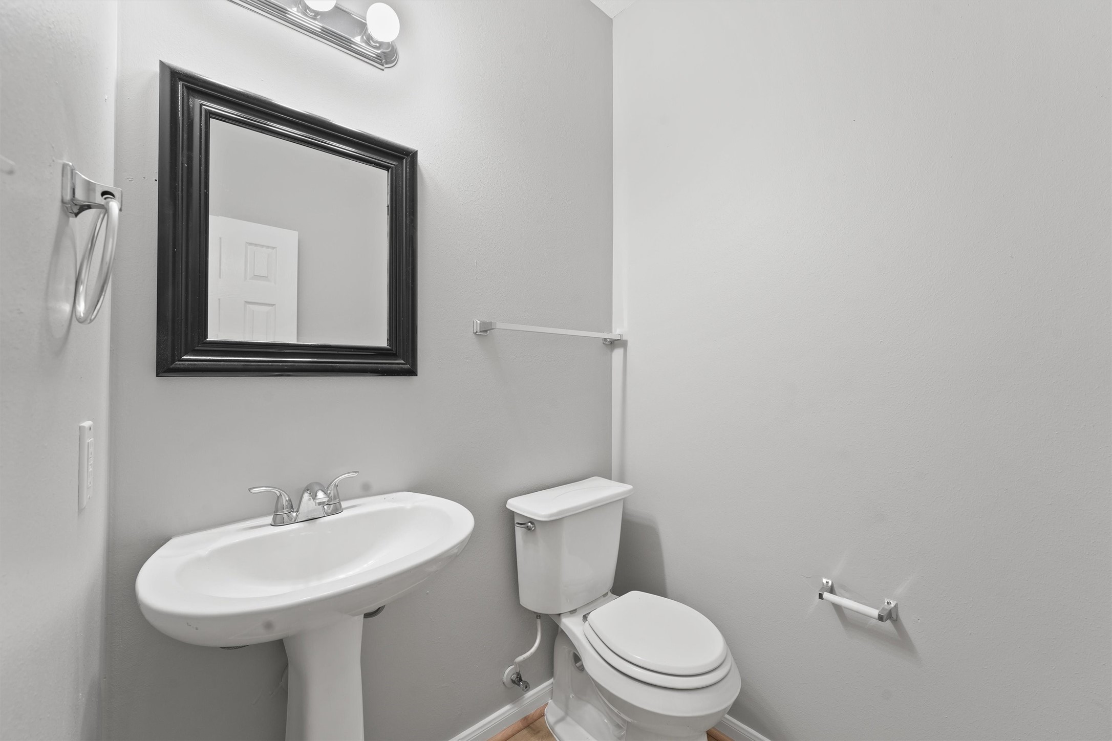 9107 Huckinston Court Spring, TX 77379 - Photo 8 of 32 a bathroom with a toilet sink and mirror