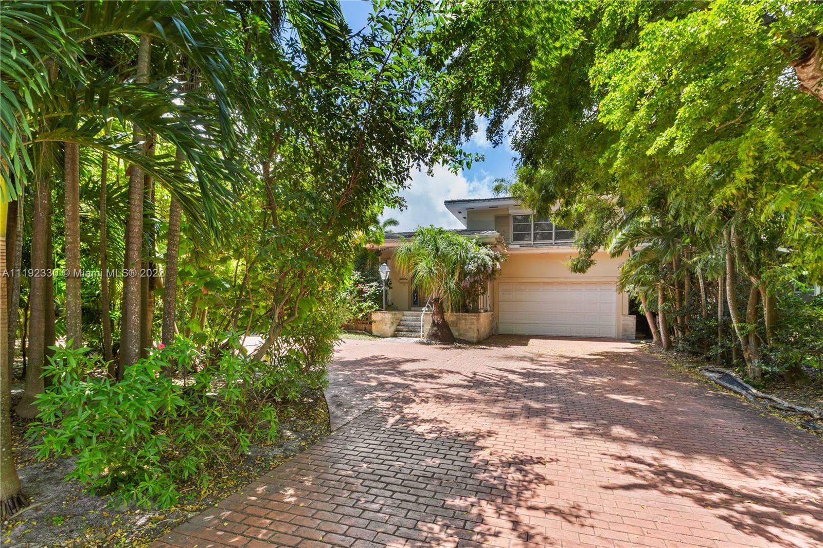 Riviera Coral Gables, FL 33146 - Photo 11 of 39 a view of a house with potted plants and large trees