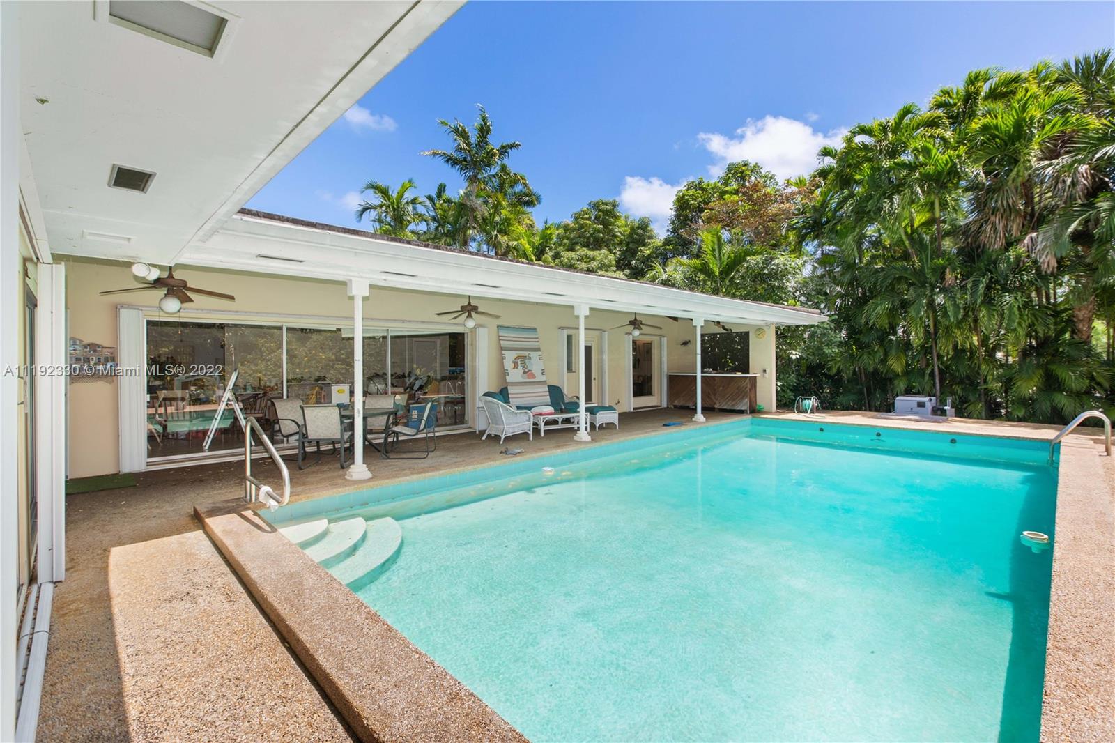 Riviera Coral Gables, FL 33146 - Photo 20 of 39 a view of a house with a backyard porch and sitting area
