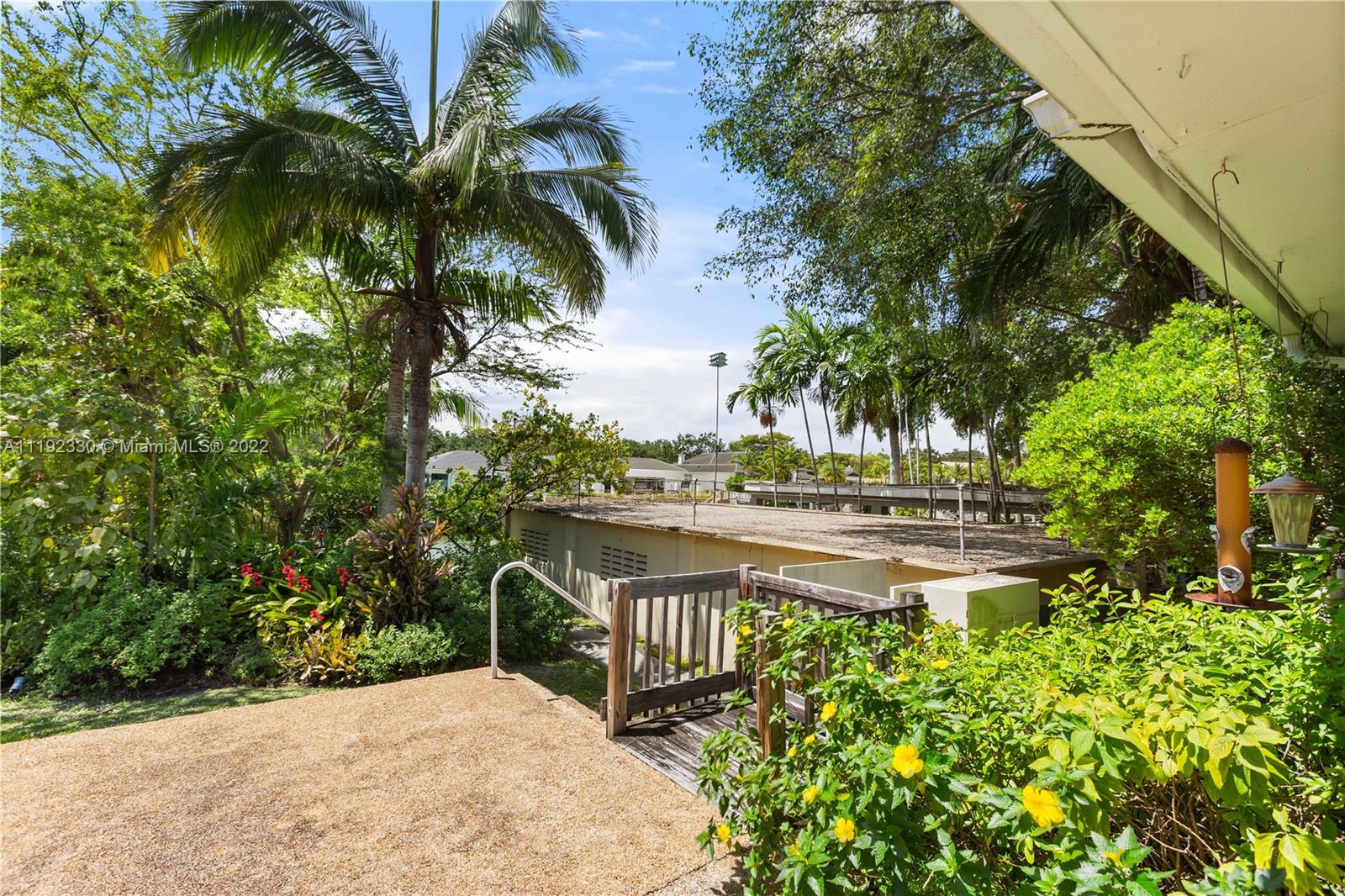 Riviera Coral Gables, FL 33146 - Photo 21 of 39 a view of a garden with a bench