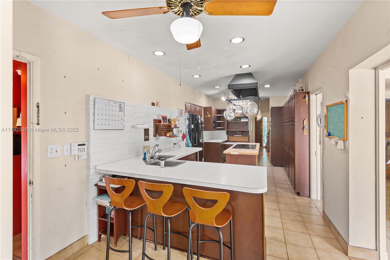 Riviera Coral Gables, FL 33146 - Photo 24 of 39 a large kitchen with a table and chairs