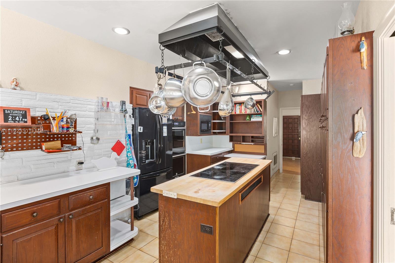 Riviera Coral Gables, FL 33146 - Photo 28 of 39 a kitchen that has a lot of cabinets and a refrigerator