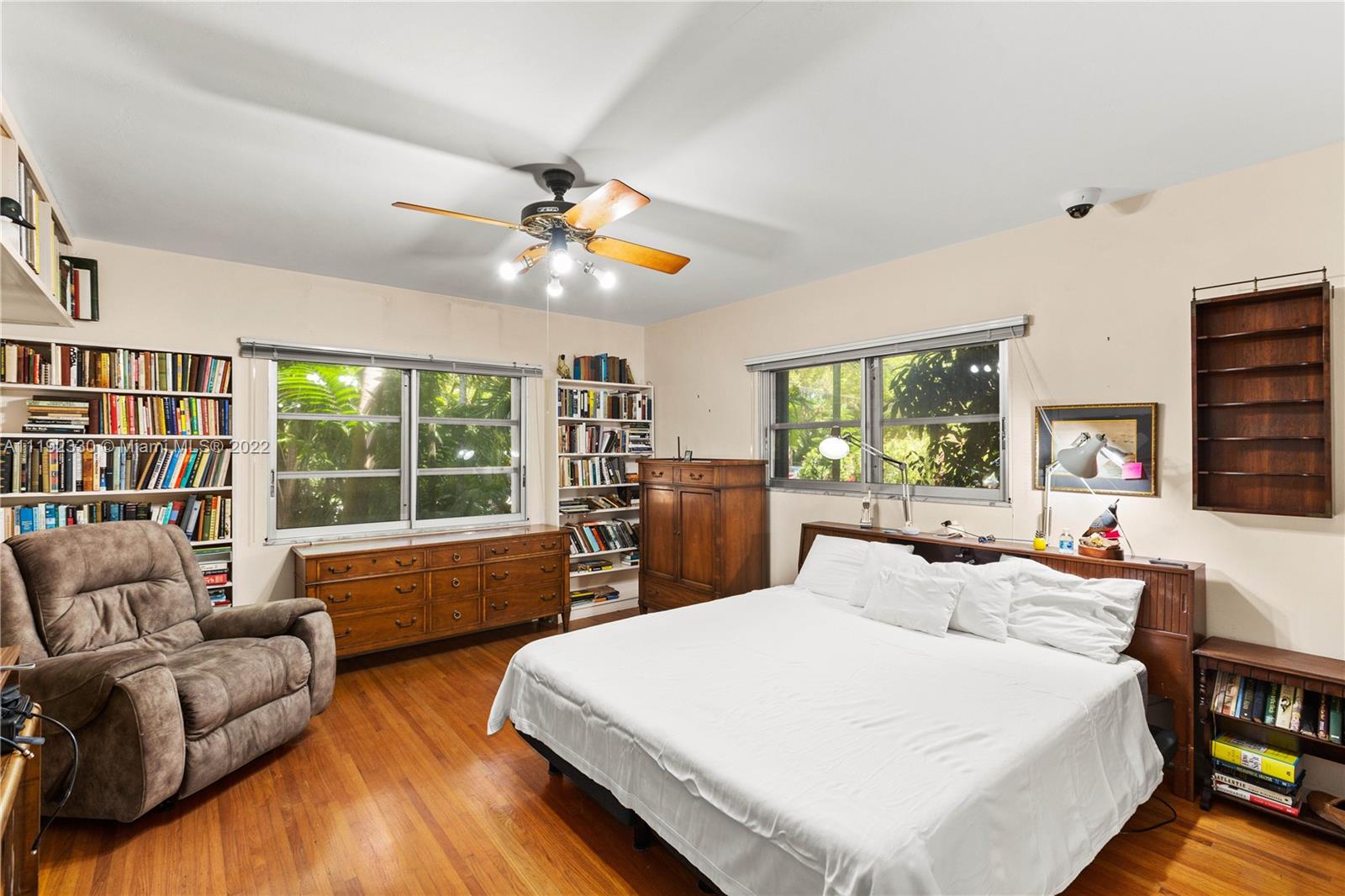 Riviera Coral Gables, FL 33146 - Photo 34 of 39 a bedroom with a large bed a flat screen tv and a large window