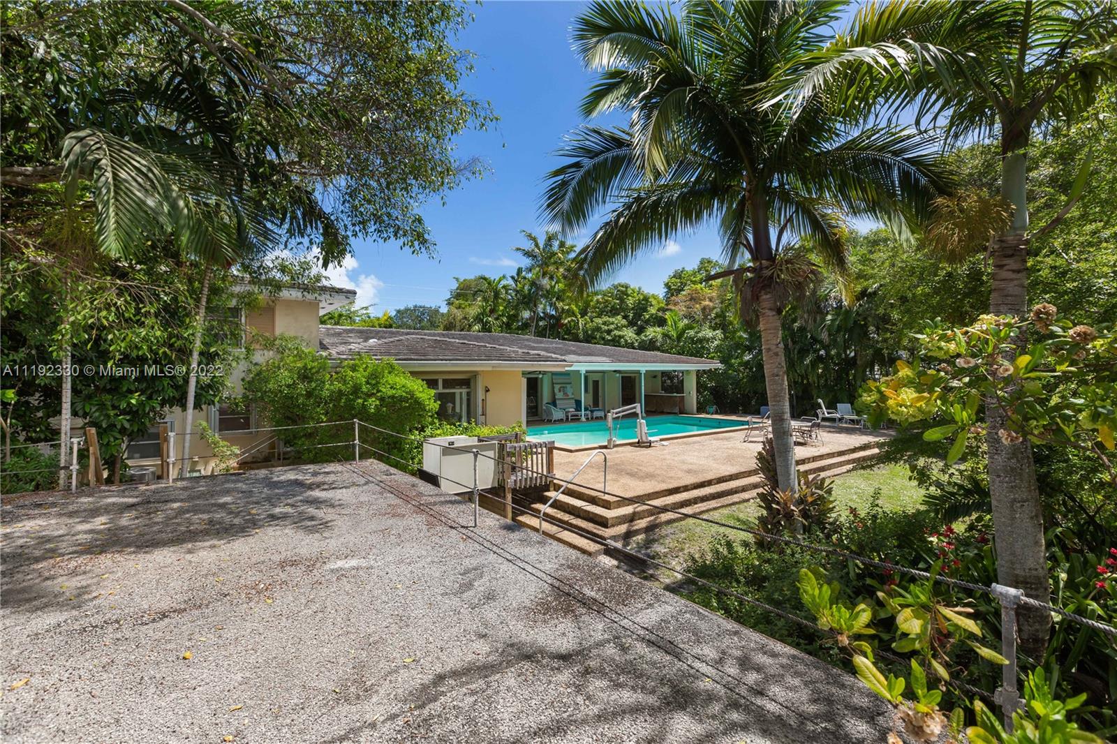 Riviera Coral Gables, FL 33146 - Photo 38 of 39 front view of a house with a yard