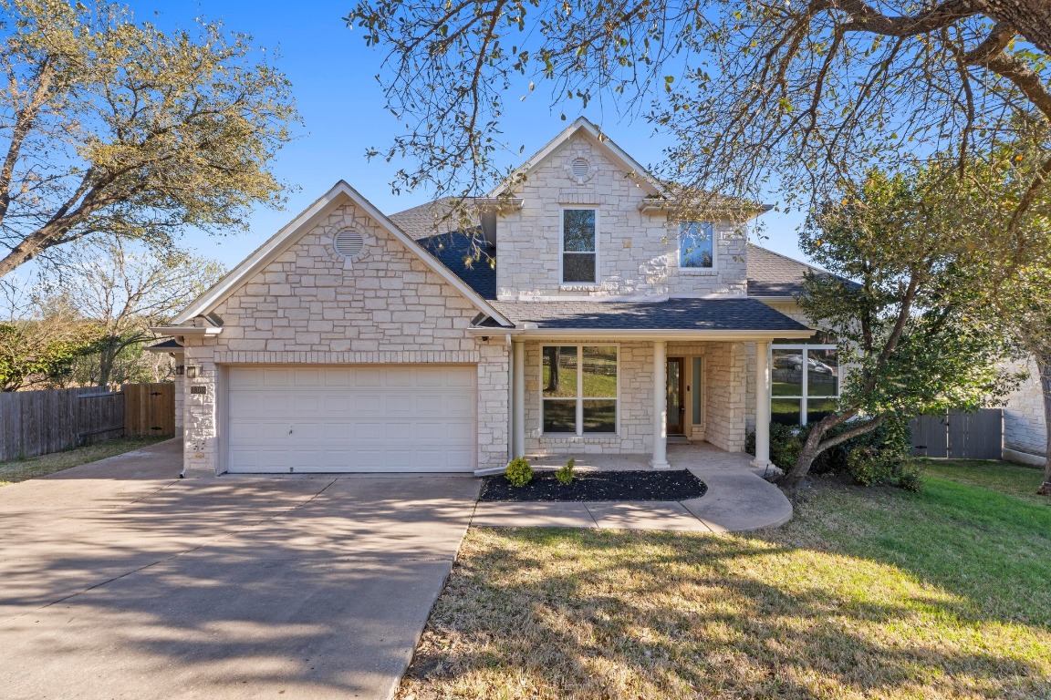 9308 Evening Primrose Path Austin, TX 78750 - Photo 1 of 1 a view of a yard in front of a house with a large tree