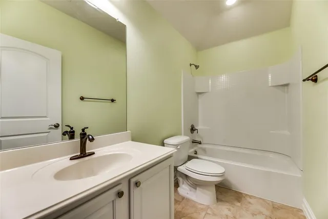 an empty room with a window and a chandelier fan