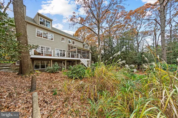 a kitchen with stainless steel appliances granite countertop a refrigerator a stove a sink dishwasher and a dining table with wooden floor