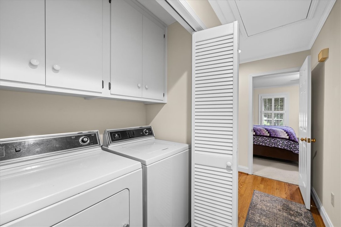2004 Cardinal Park Drive Anderson, SC 29621 - Photo 33 of 40 Functional laundry closets feature overhead storage cabinets set above a classic washer and dryer.