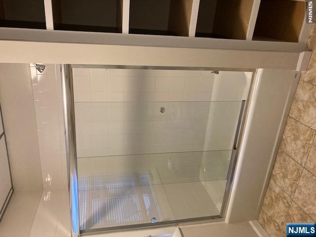 129 Union Street Hackensack, NJ 07601 - Photo 6 of 10 a bathroom with a glass shower door
