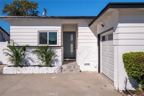 a potted plant sitting in front of a house