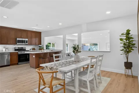 a kitchen with granite countertop a counter space a sink stainless steel appliances and cabinets
