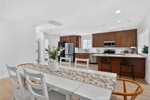 a kitchen with stainless steel appliances granite countertop a stove a sink a microwave a refrigerator and cabinets