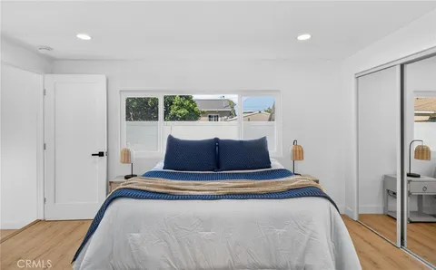 a bed sitting in a bedroom next to a window