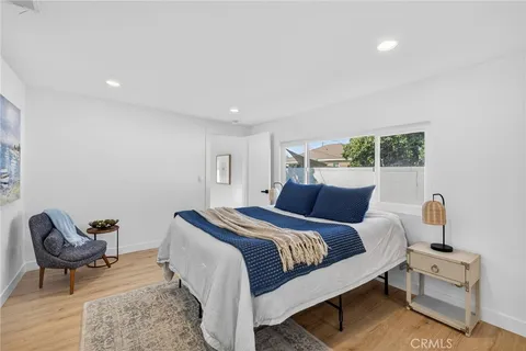 a bed room with a bed and chair