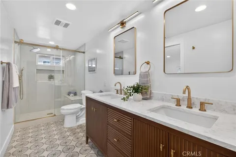 a bathroom with a sink a toilet and a mirror