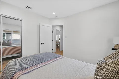 a bedroom with a bed and a walk in closet