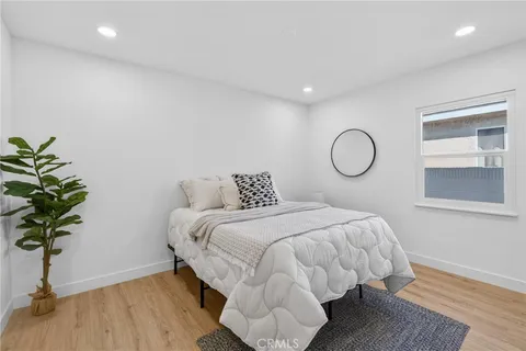 a bedroom with bed and a potted plant