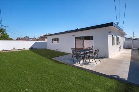 a view of a backyard with table and chairs