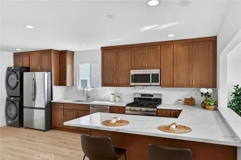 a kitchen with a sink stove top oven and refrigerator