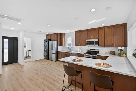 a kitchen with stainless steel appliances a stove a sink a refrigerator and cabinets