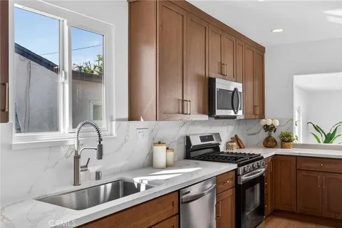 a kitchen with a sink cabinets and stainless steel appliances