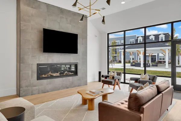 a living room with furniture a flat screen tv and a fireplace