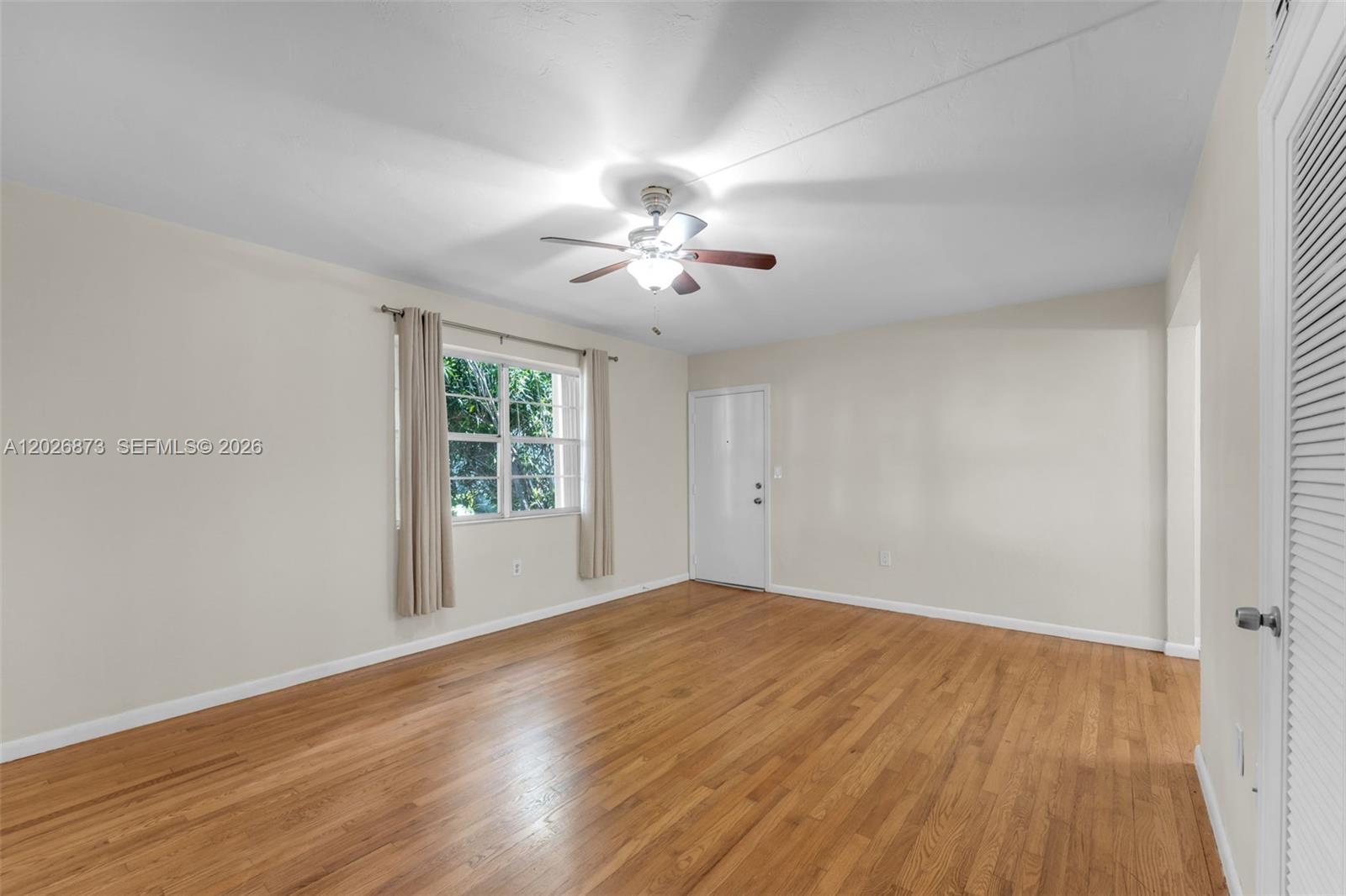 5590 Southwest 78th Street, Unit 133B Miami, FL 33143 - Photo 3 of 18 wooden floor in an empty room with a window