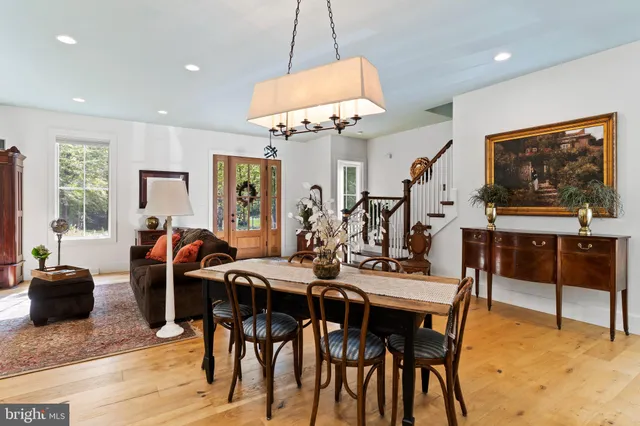 a kitchen with a table chairs and refrigerator