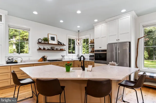 a kitchen with white cabinets and sink
